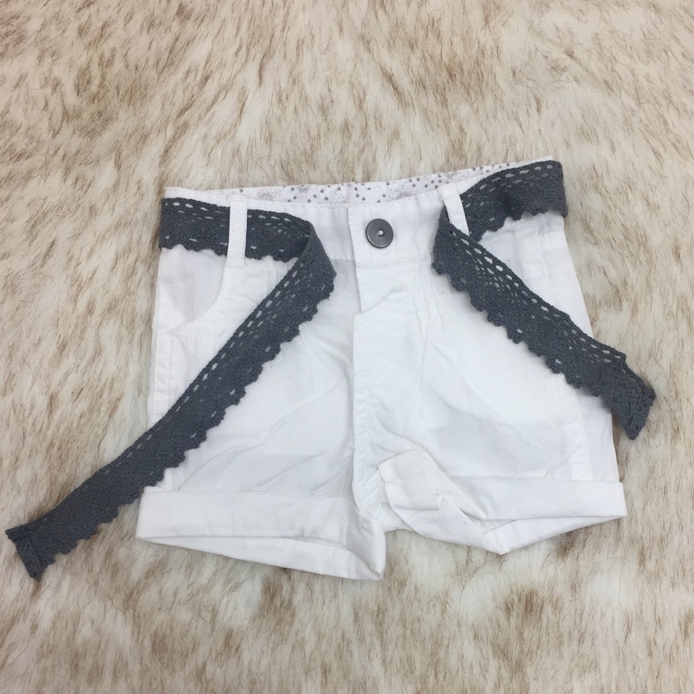White shorts and gray belt